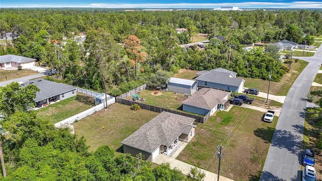 aerial view of residential area featuring a forest