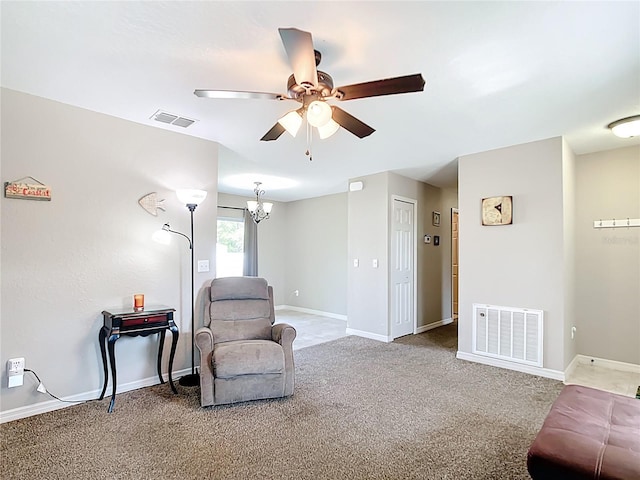 living area featuring ceiling fan, baseboards, and carpet floors