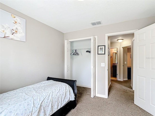 bedroom with carpet flooring, baseboards, and a closet
