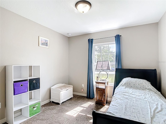 bedroom with carpet floors and baseboards