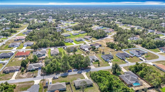 aerial view of property and surrounding area featuring nearby suburban area