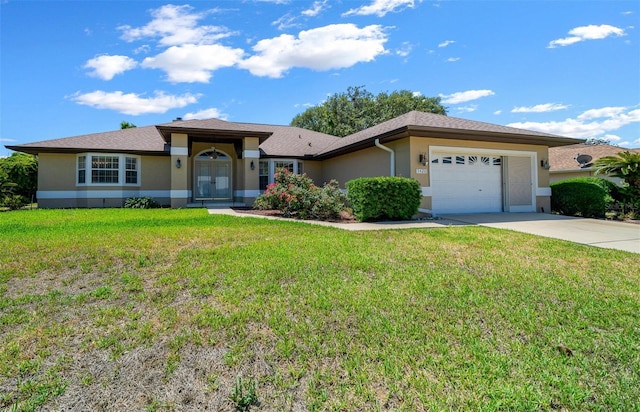view of front of home with an attached garage, driveway, a front yard, and stucco siding