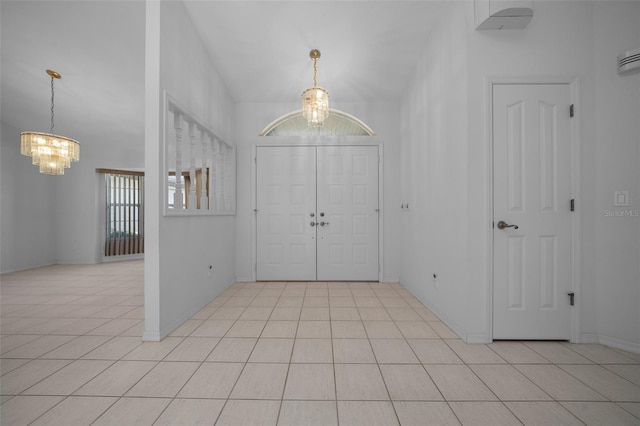 foyer with light tile patterned floors and a notable chandelier