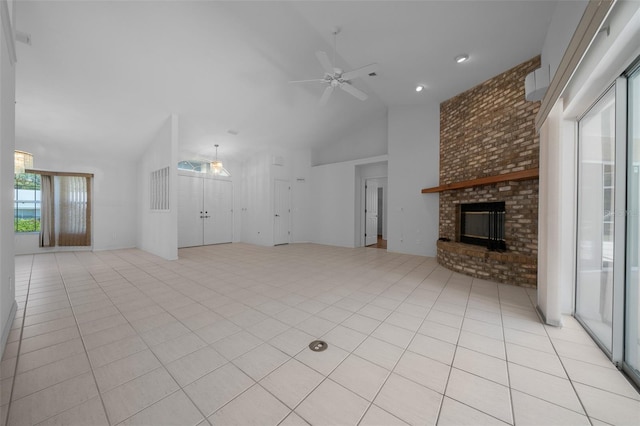 unfurnished living room with light tile patterned flooring, ceiling fan, high vaulted ceiling, and a fireplace