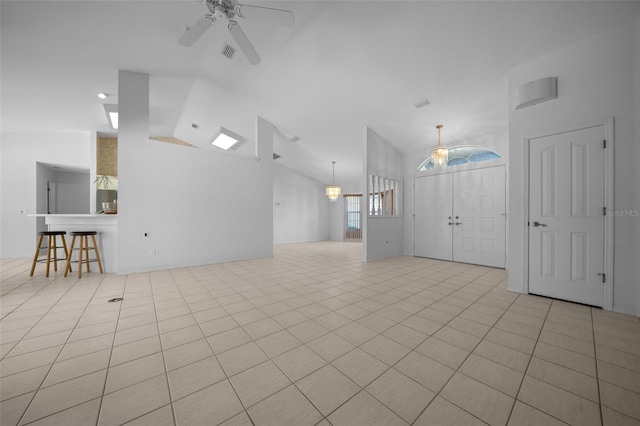 unfurnished living room featuring visible vents, a ceiling fan, tile patterned flooring, and high vaulted ceiling