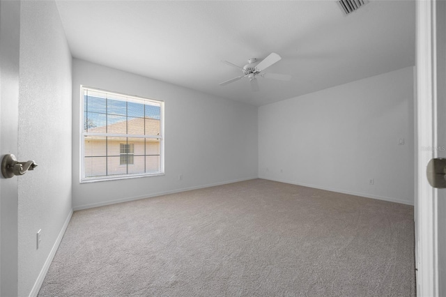 unfurnished room featuring baseboards, ceiling fan, carpet, and visible vents