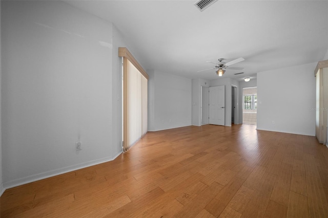 spare room with a ceiling fan, baseboards, visible vents, and light wood-style floors