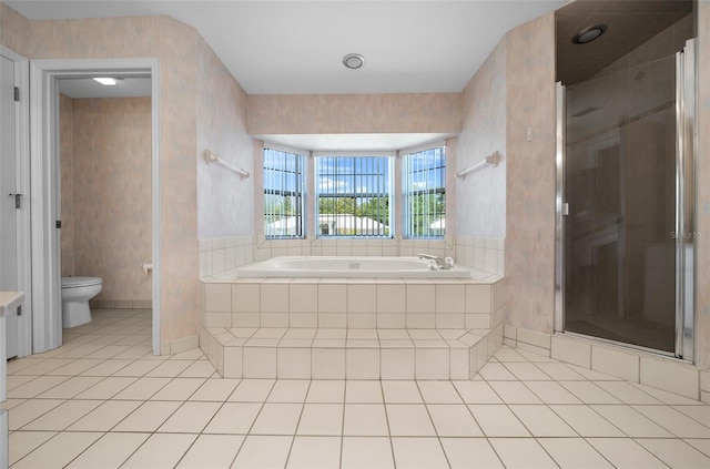 full bath with tile patterned flooring, a bath, toilet, and a shower stall