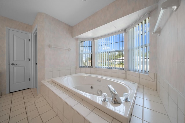 full bathroom with tile patterned flooring and a tub with jets
