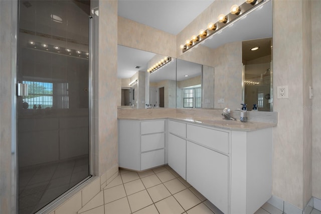 bathroom featuring tiled shower, tile patterned flooring, and vanity