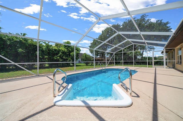 pool with glass enclosure and a patio area