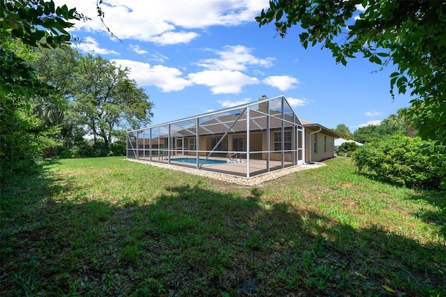 exterior space featuring a patio, glass enclosure, and an outdoor pool