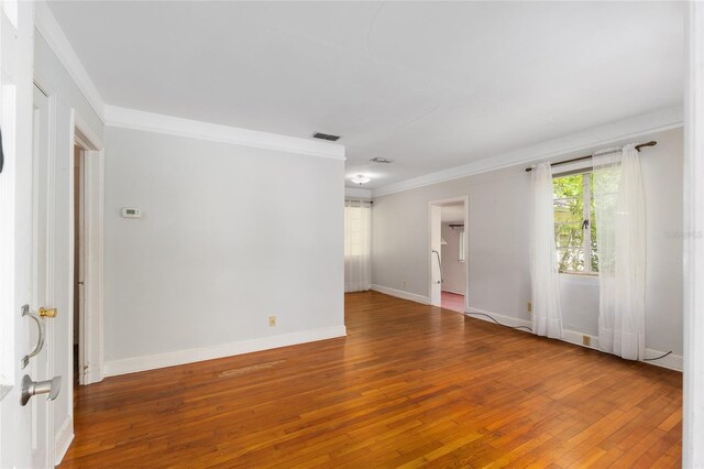 608 SE 31st Ter, Ocala, FL 34471 - spare room featuring wood-type flooring, visible vents, baseboards, and ornamental molding