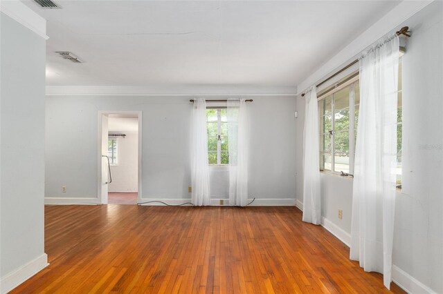608 SE 31st Ter, Ocala, FL 34471 - unfurnished room featuring a wealth of natural light, baseboards, hardwood / wood-style floors, and visible vents