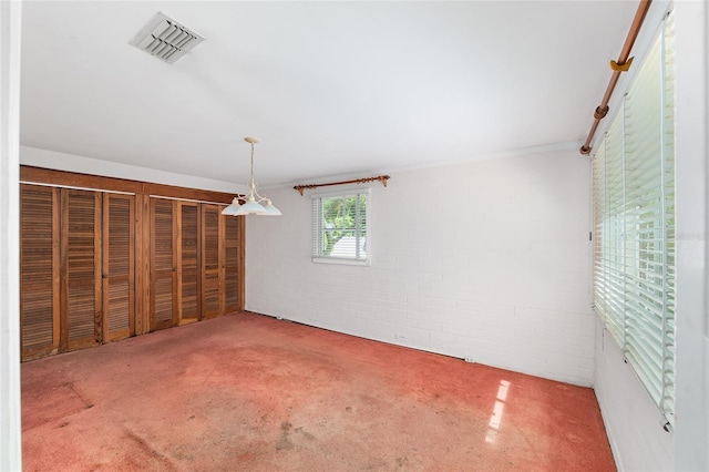 608 SE 31st Ter, Ocala, FL 34471 - spare room with brick wall, visible vents, and carpet