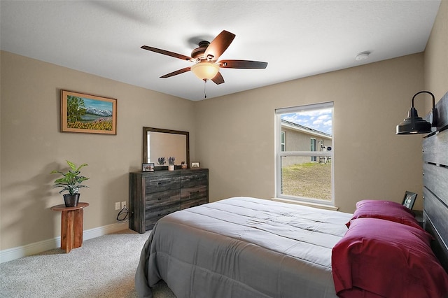 carpeted bedroom with baseboards and a ceiling fan