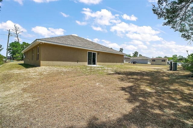 rear view of property with stucco siding