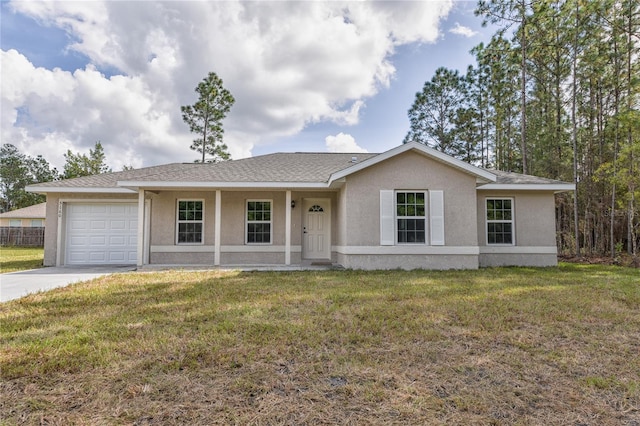 ranch-style home featuring an attached garage, stucco siding, driveway, and a front yard