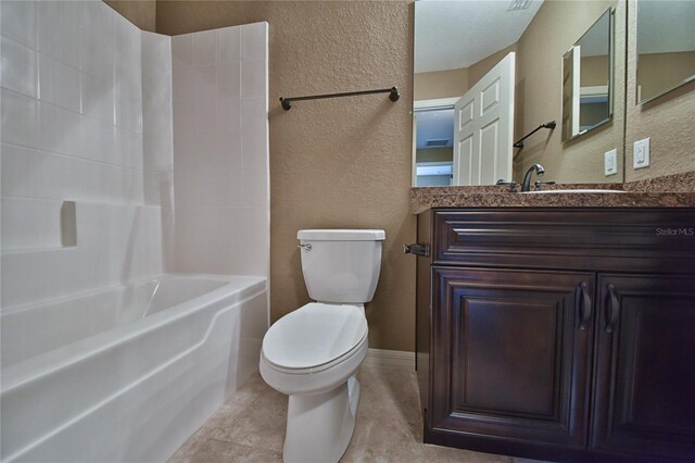 full bathroom featuring vanity, a textured wall, bathtub / shower combination, and toilet
