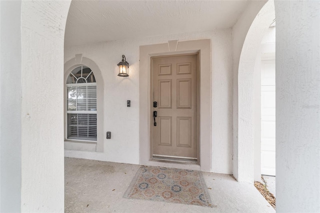 view of exterior entry with stucco siding