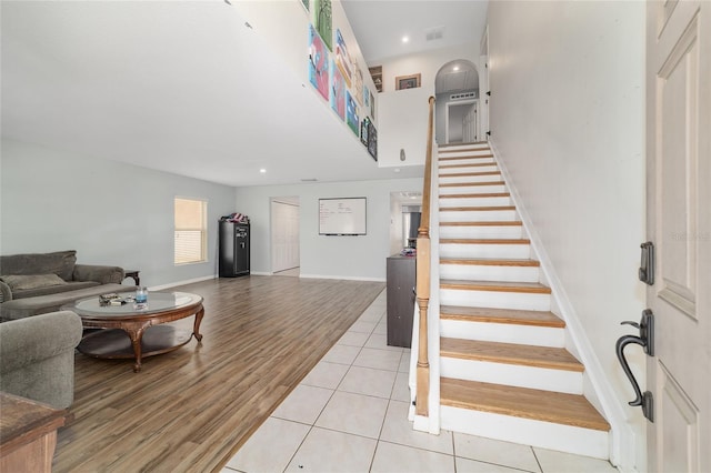 staircase featuring baseboards, recessed lighting, wood finished floors, and visible vents