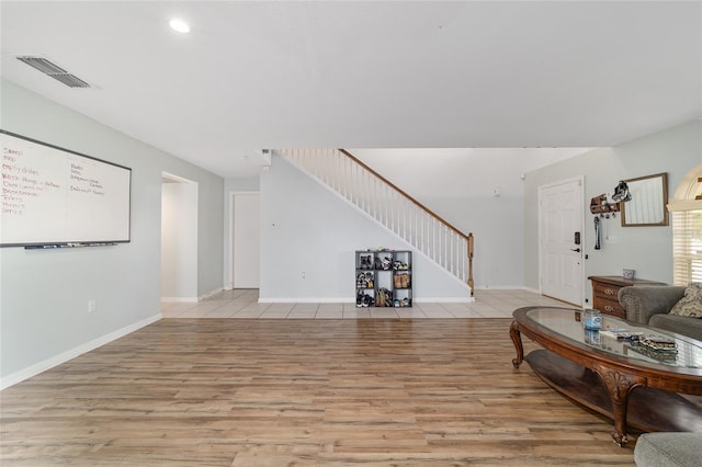 living room with visible vents, baseboards, stairway, recessed lighting, and light wood-style flooring