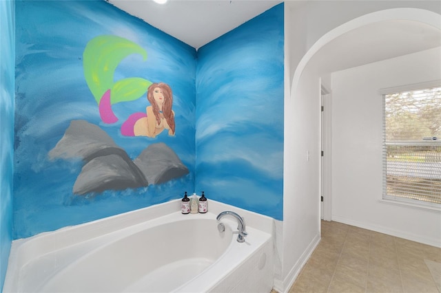 full bathroom with tile patterned floors, baseboards, and a bath