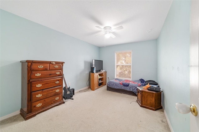 bedroom featuring a ceiling fan, baseboards, and carpet