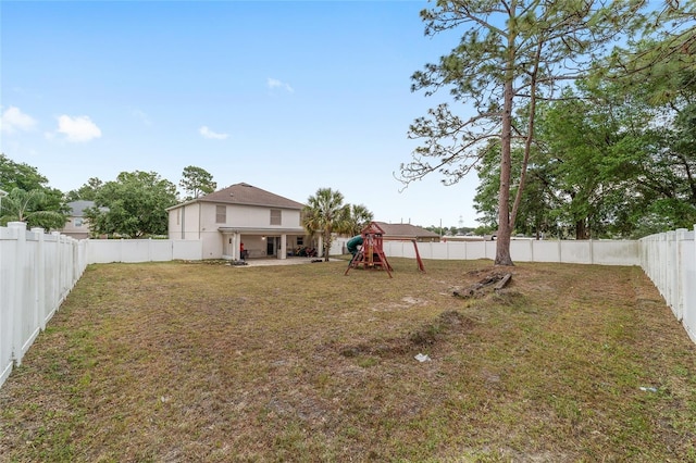 view of yard with a playground and a fenced backyard