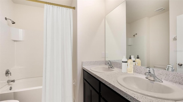full bathroom with visible vents, a sink, shower / bath combination with curtain, and double vanity
