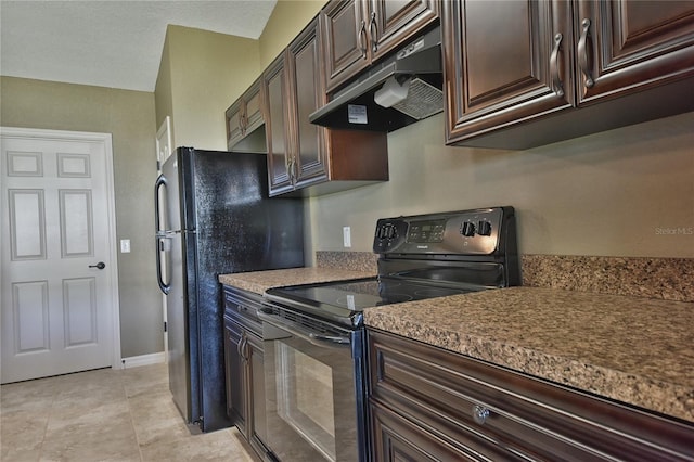 kitchen featuring dark brown cabinets, light tile patterned floors, baseboards, black appliances, and under cabinet range hood