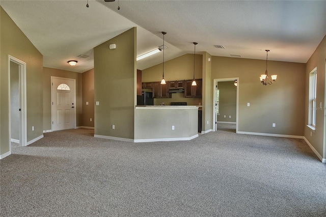 unfurnished living room featuring carpet floors, baseboards, a notable chandelier, and lofted ceiling