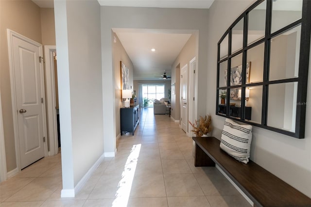 hallway with light tile patterned floors, baseboards, and recessed lighting