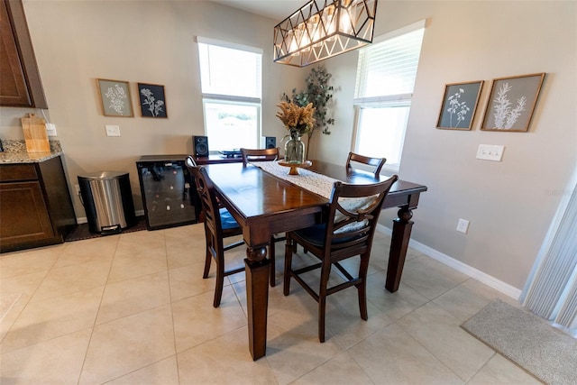 dining space featuring light tile patterned floors and baseboards