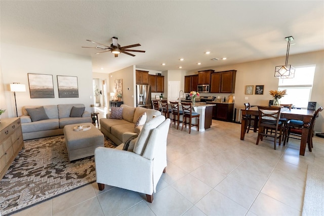 living room featuring light tile patterned floors, a ceiling fan, and recessed lighting