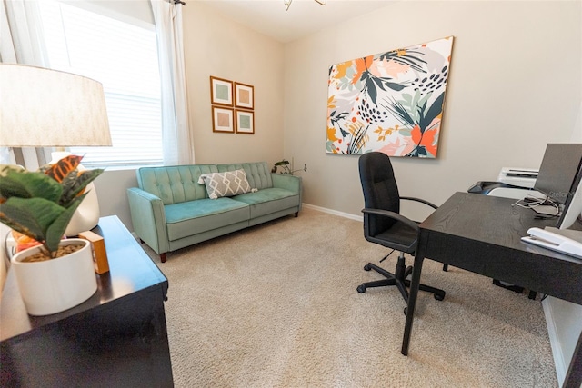 carpeted office featuring baseboards