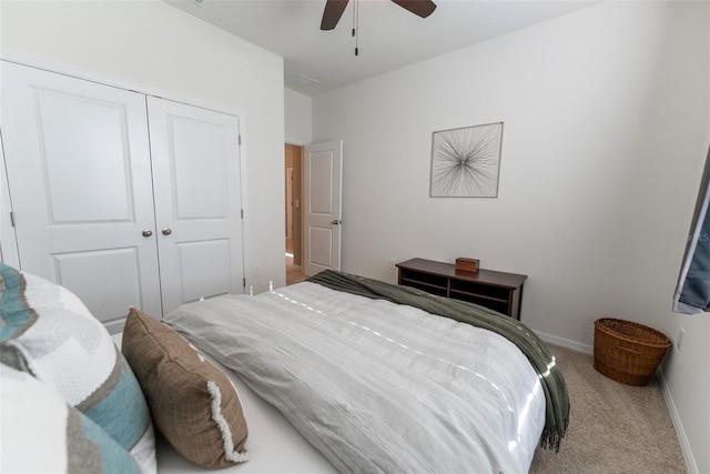 carpeted bedroom with a ceiling fan, baseboards, and a closet