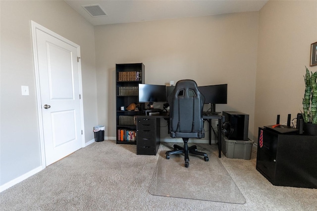 home office with carpet floors, baseboards, and visible vents