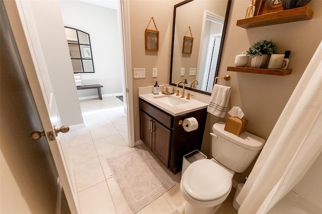 bathroom featuring toilet, tile patterned flooring, and vanity