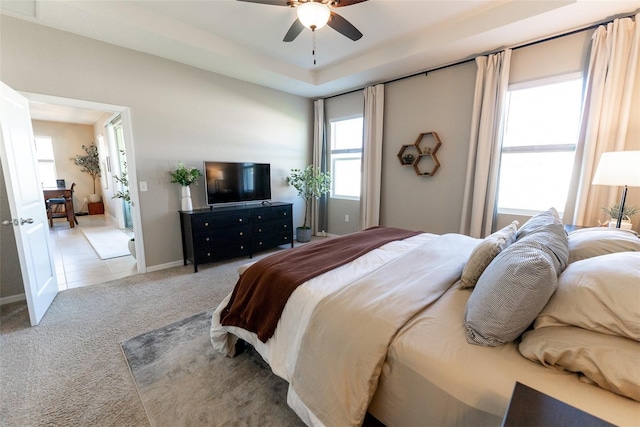 bedroom featuring light colored carpet and a ceiling fan