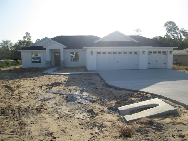 ranch-style home with an attached garage and driveway