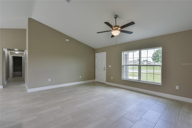empty room with a ceiling fan, baseboards, and lofted ceiling
