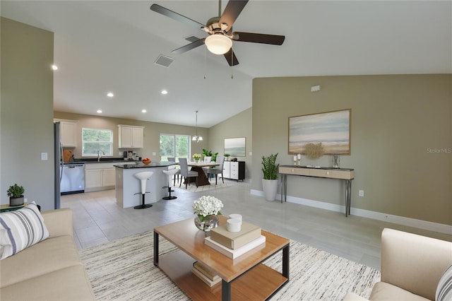 living room featuring light tile patterned flooring, a ceiling fan, recessed lighting, vaulted ceiling, and visible vents