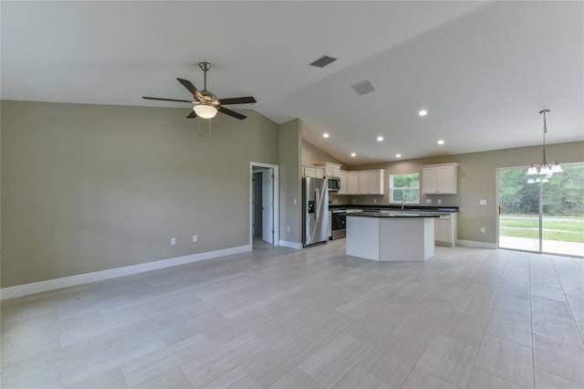 kitchen featuring visible vents, open floor plan, dark countertops, and stainless steel appliances