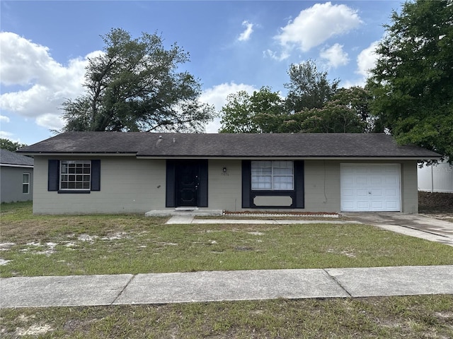 single story home featuring an attached garage, concrete block siding, roof with shingles, and a front lawn