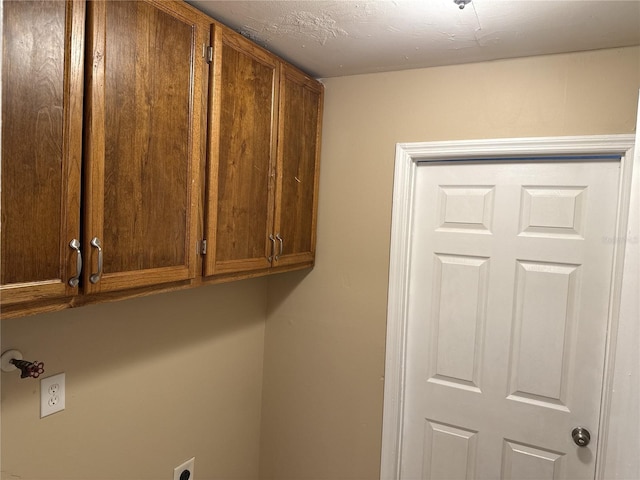 laundry room featuring cabinet space and hookup for an electric dryer