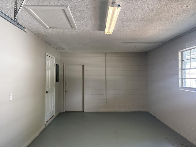 spare room featuring finished concrete flooring and a textured ceiling