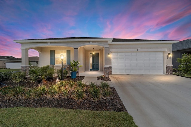 7706 SW 89th Ct, Ocala, FL 34481 - view of front of property featuring a garage, stucco siding, concrete driveway, stone siding, and a porch