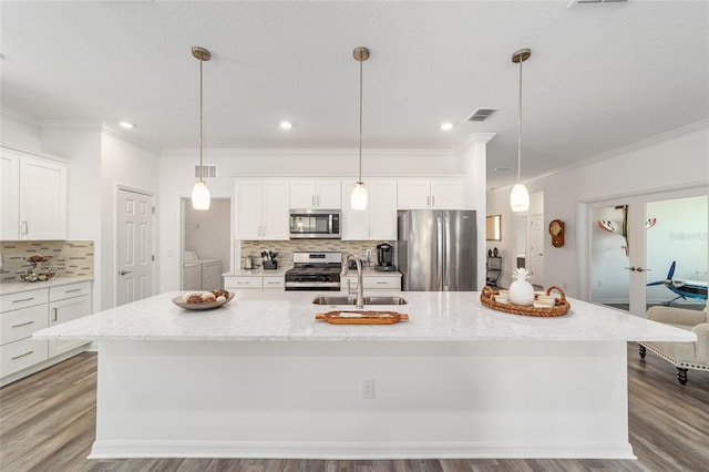 7706 SW 89th Ct, Ocala, FL 34481 - kitchen featuring crown molding, washing machine and dryer, appliances with stainless steel finishes, and a sink
