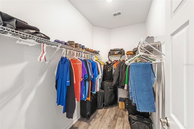 7706 SW 89th Ct, Ocala, FL 34481 - walk in closet with visible vents and wood finished floors